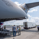 Tractor trailer being loaded on a C-17 Globemaster III.